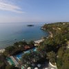 Costa con spiaggia e piscina vicino al mare.