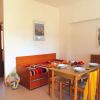 Interno accogliente con tavolo da pranzo e divano letto, decorato con quadri alle pareti.