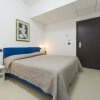 Camera moderna con letto matrimoniale e pareti bianche.