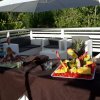 Tavoli con frutta esotica e sedute bianche all'aperto.