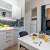 Cucina bianca con tavolo e colazione servita.
