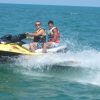 Due persone su una moto d'acqua gialla in mare.