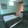 Stanza d'albergo con letto matrimoniale e televisore.