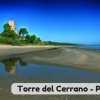 Torre accanto a una spiaggia con riflessi sull'acqua.