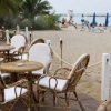 Terrazza sulla spiaggia con tavolini e sedie.